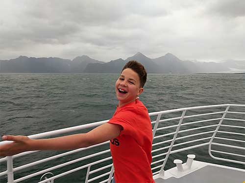 Iden Elliott in t-shirt on ship deck