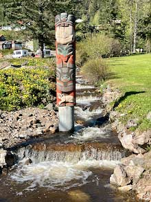 Hoonah totem pole in creek