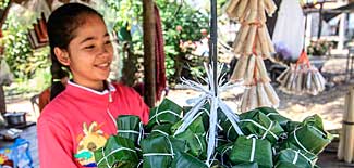 Cambodian girl with sticky rice boxes